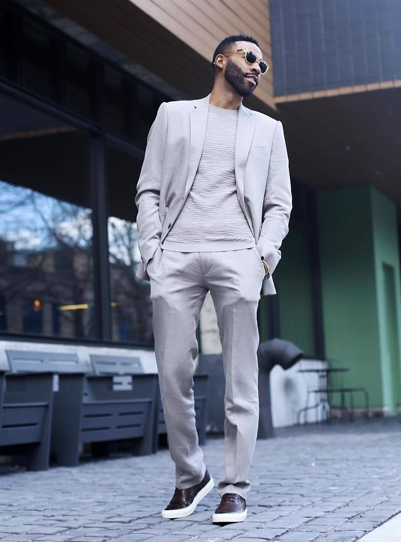grey suit, grey crew neck t-shirt, and brown sneakers