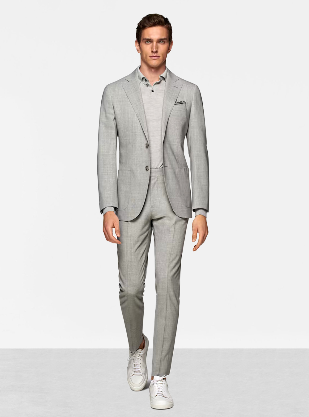 grey suit, grey polo shirt, and white sneakers