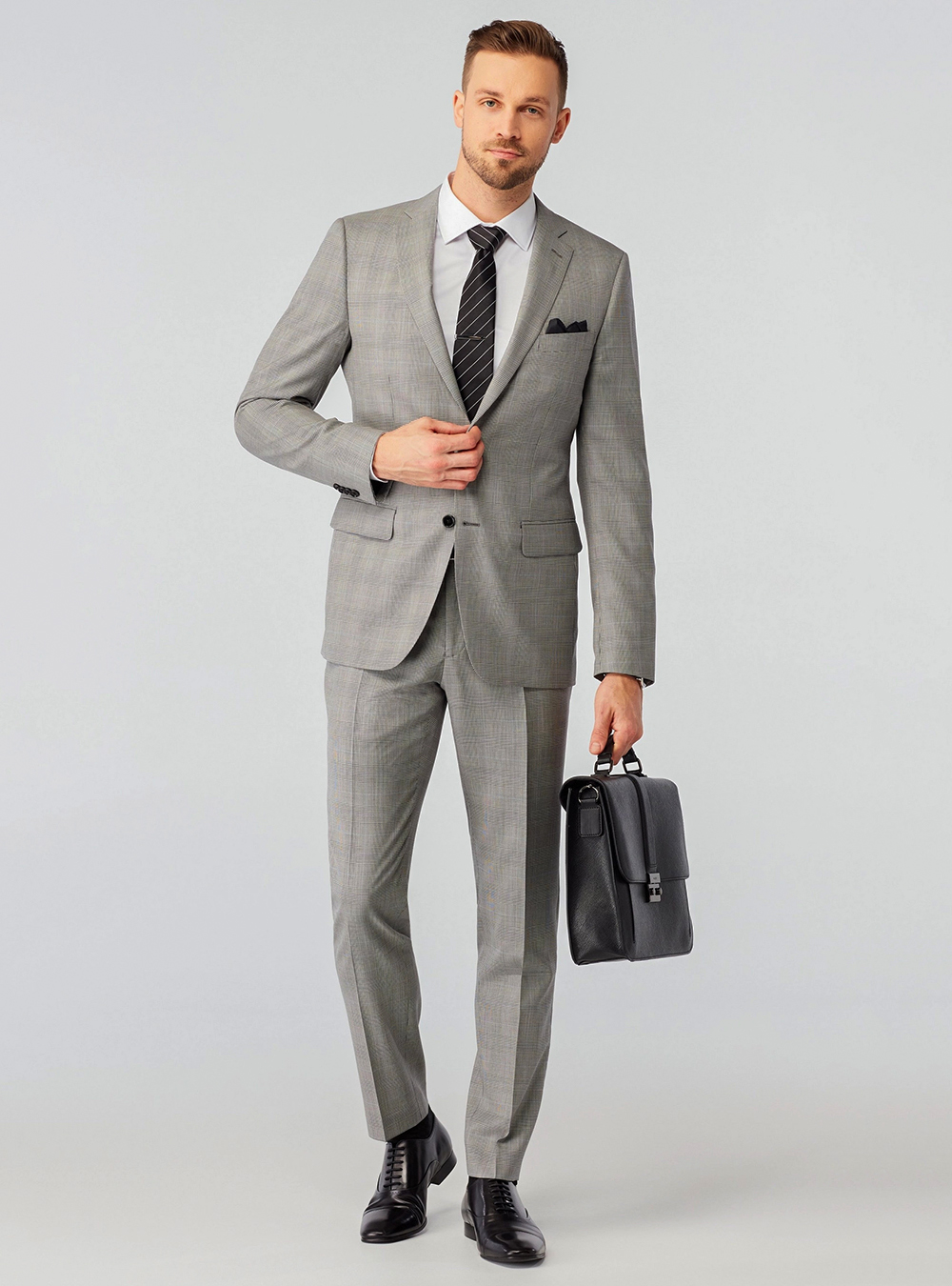 Grey suit, white dress shirt, black tie and black oxford shoes