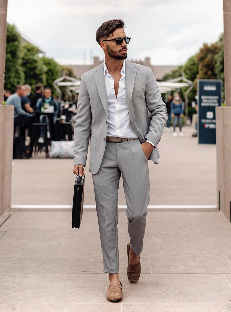 grey suit, white shirt, and brown suede loafers