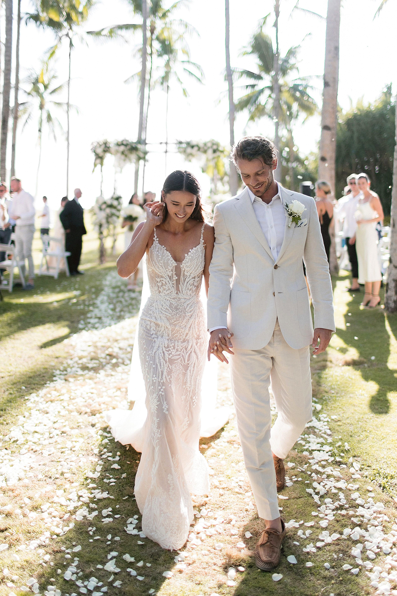 groom wears beige wedding suit and light brown lace-up shoes