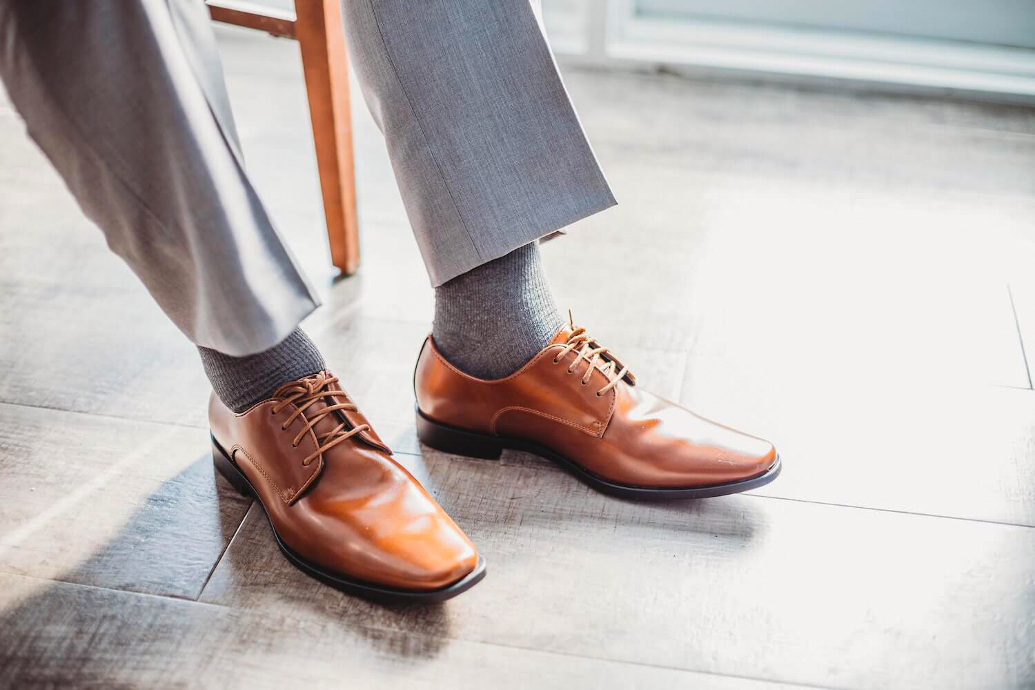 grey suit pants, grey socks, and brown shoes