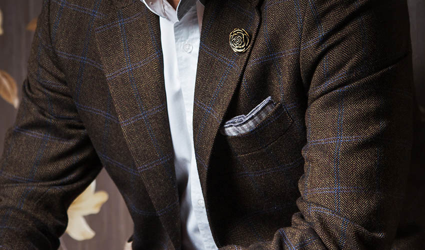 brown plaid suit with a pocket square