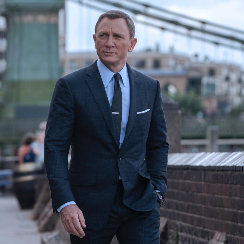 James Bond in a charcoal grey suit and tie