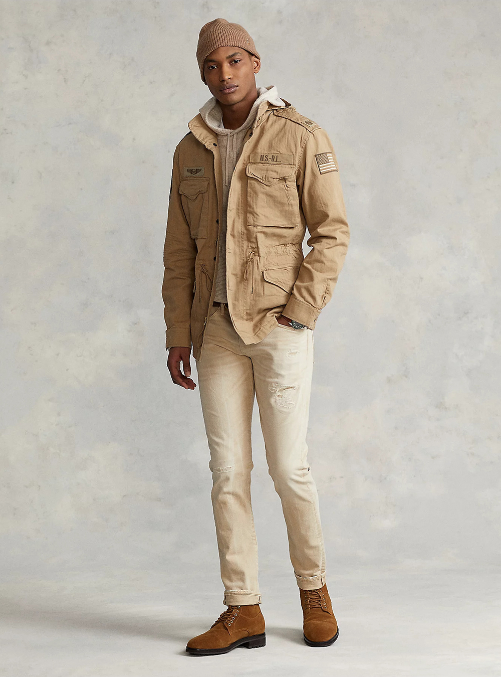 khaki jacket, taupe hoodie, tan jeans, and brown suede chukka boots