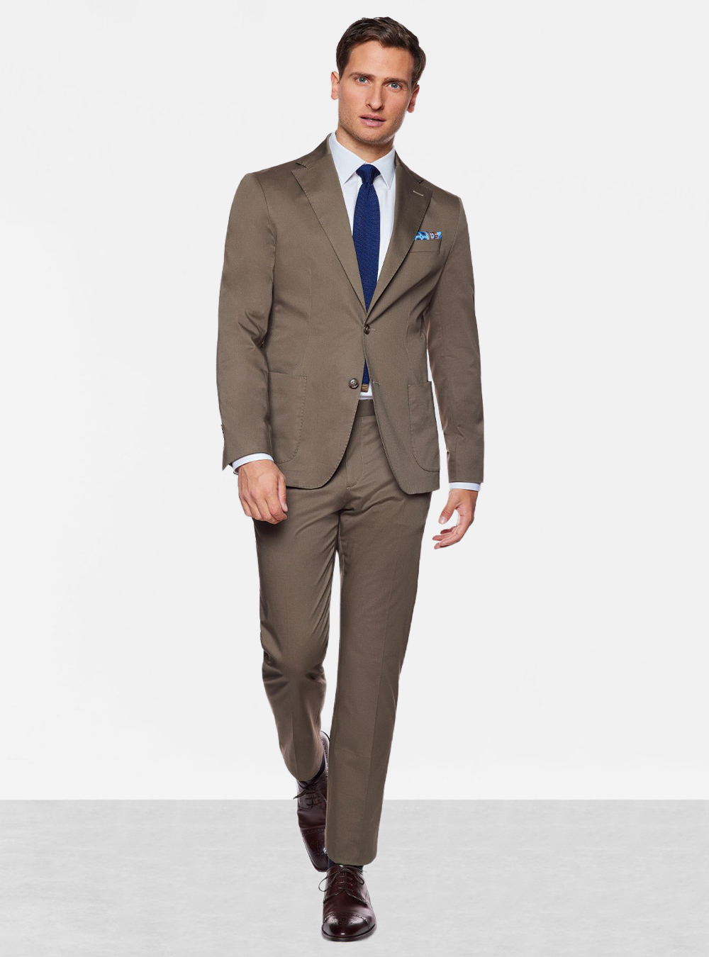 khaki suit, white shirt, blue tie, and burgundy derby shoes