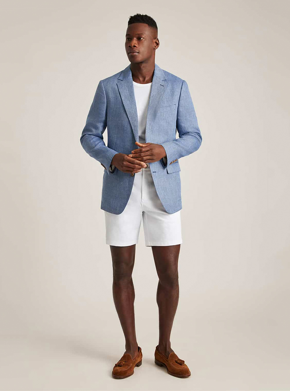 light blue blazer, white T-shirt, white shorts, and brown suede loafers