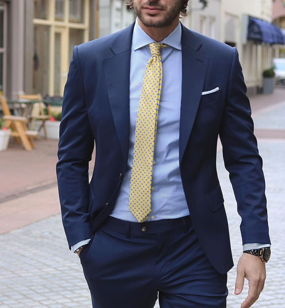 light blue stipe pattern shirt and yellow patterned tie