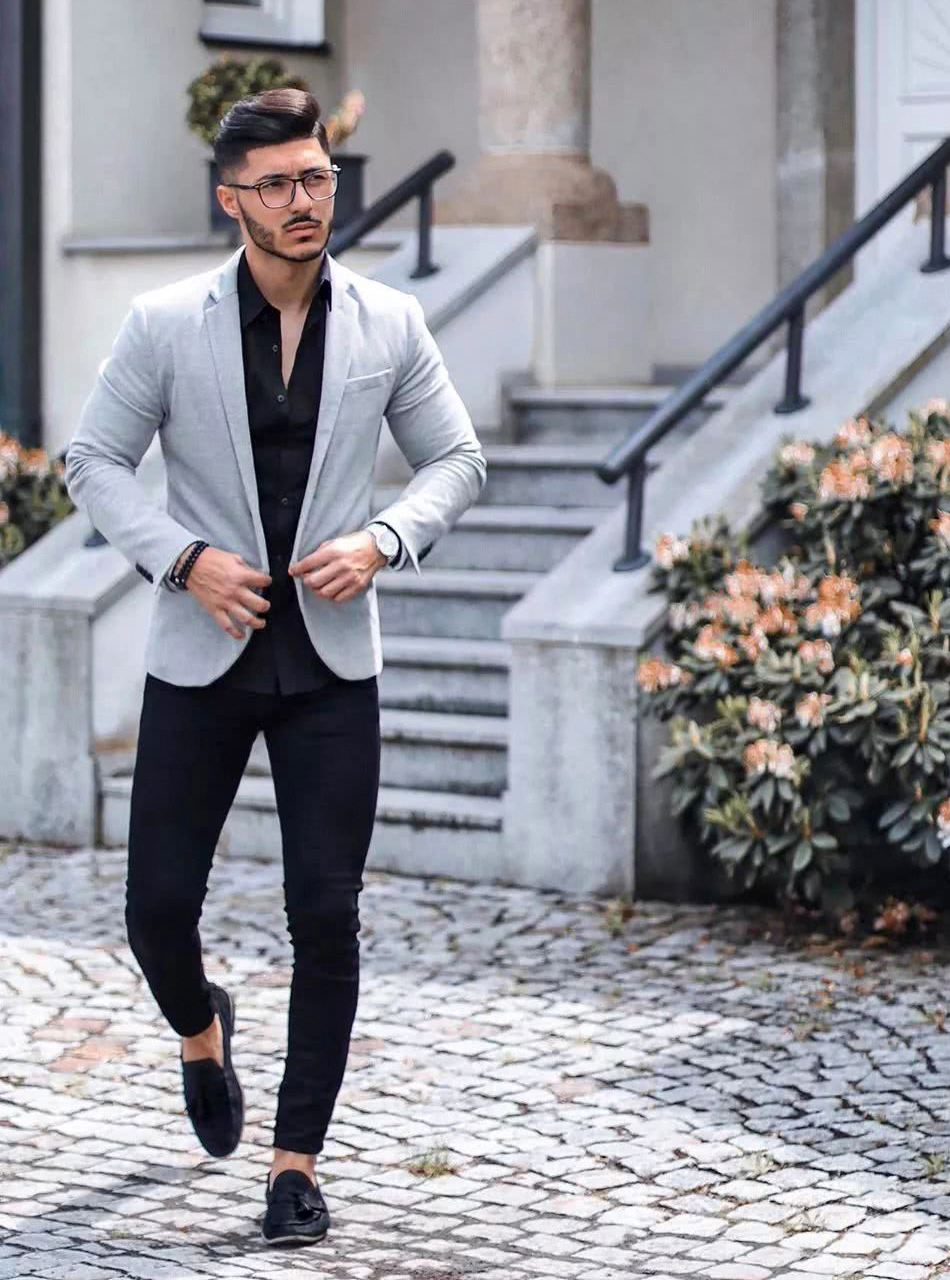 light grey blazer, black shirt, and black pants