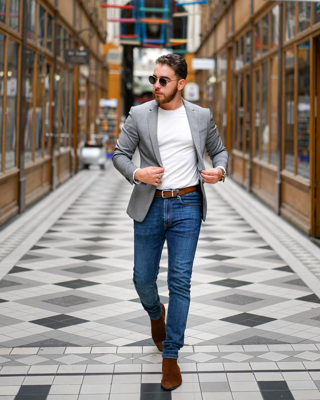 Light grey blazer, long sleeve white shirt, blue jeans, and brown suede Chelsea boots
