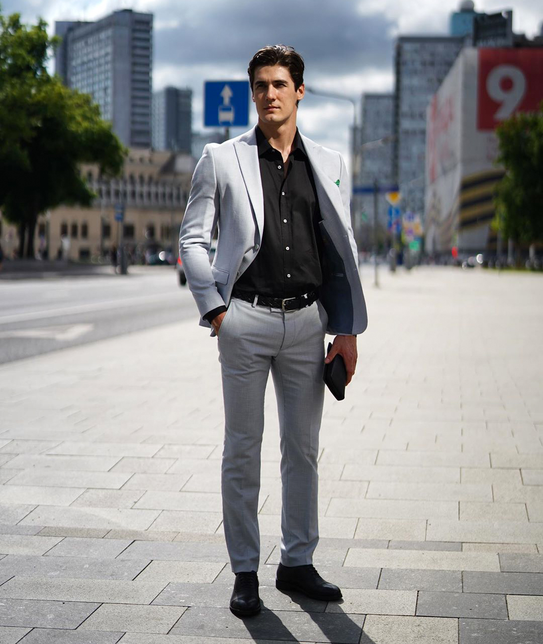 light grey suit and black shirt with black Oxford shoes