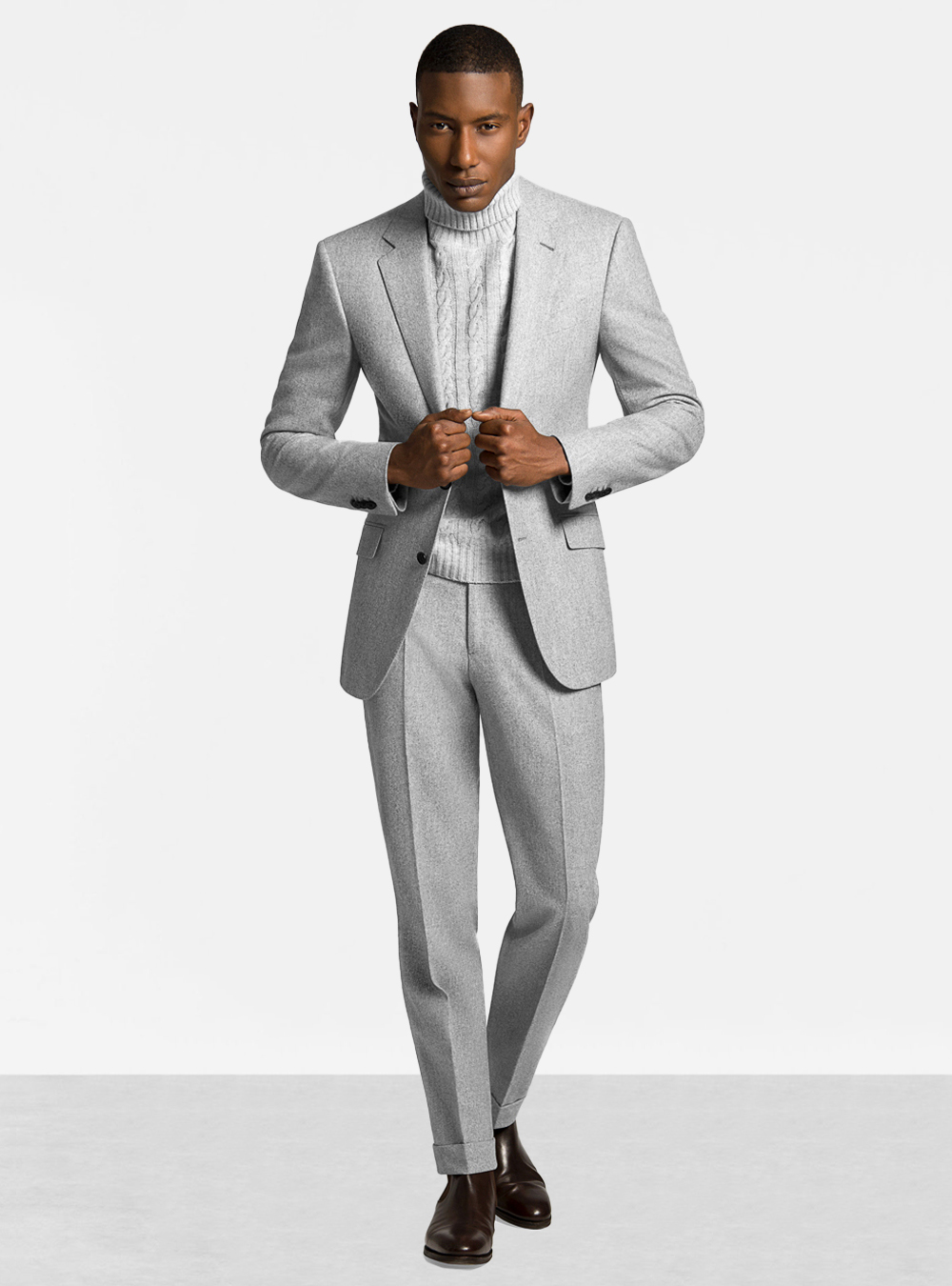 light grey suit, beige turtleneck, and brown Chelsea boots