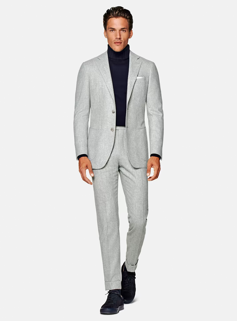 Light grey suit, navy turtleneck, and navy sneakers