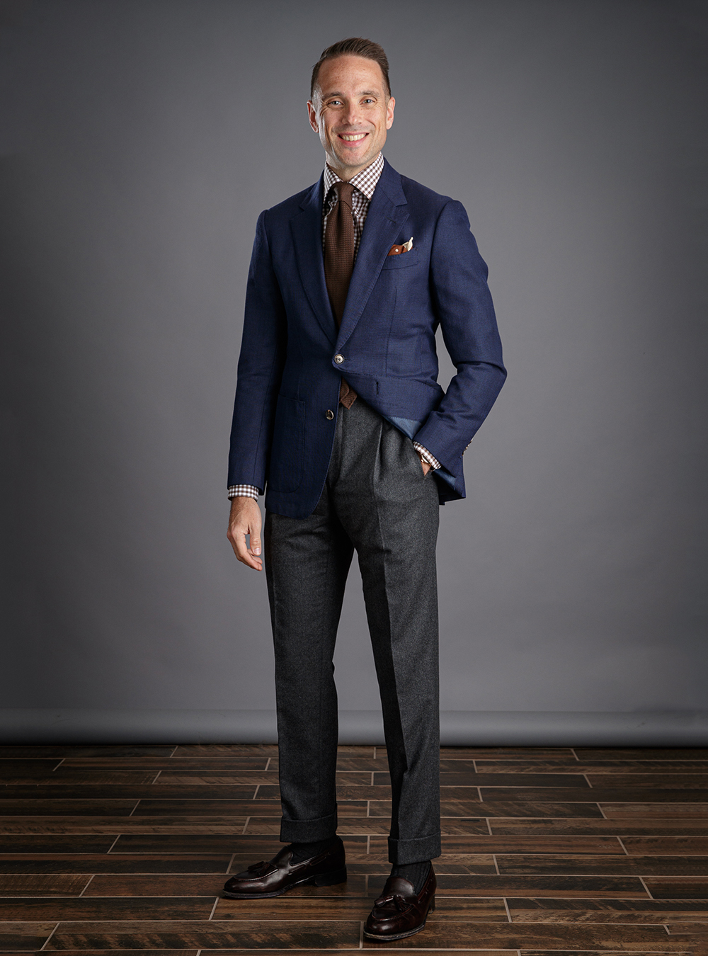 navy blazer, brown gingham shirt, and brown leather loafers