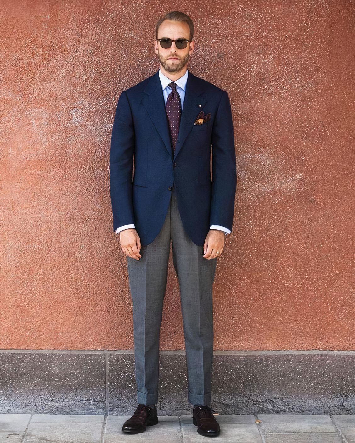 Navy blazer, grey trousers, burgundy tie, and dark brown shoes