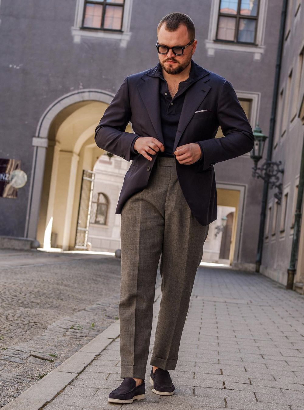 grey pants with navy blazer, polo T-shirt, and loafers