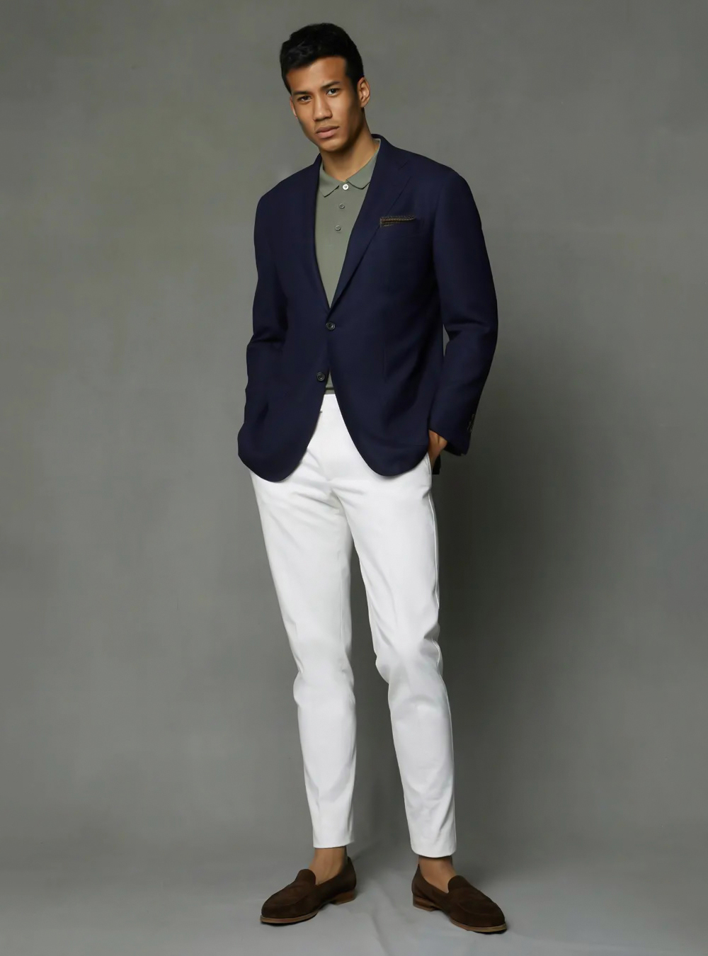 navy blazer, olive green polo shirt, white pants, and brown suede loafers