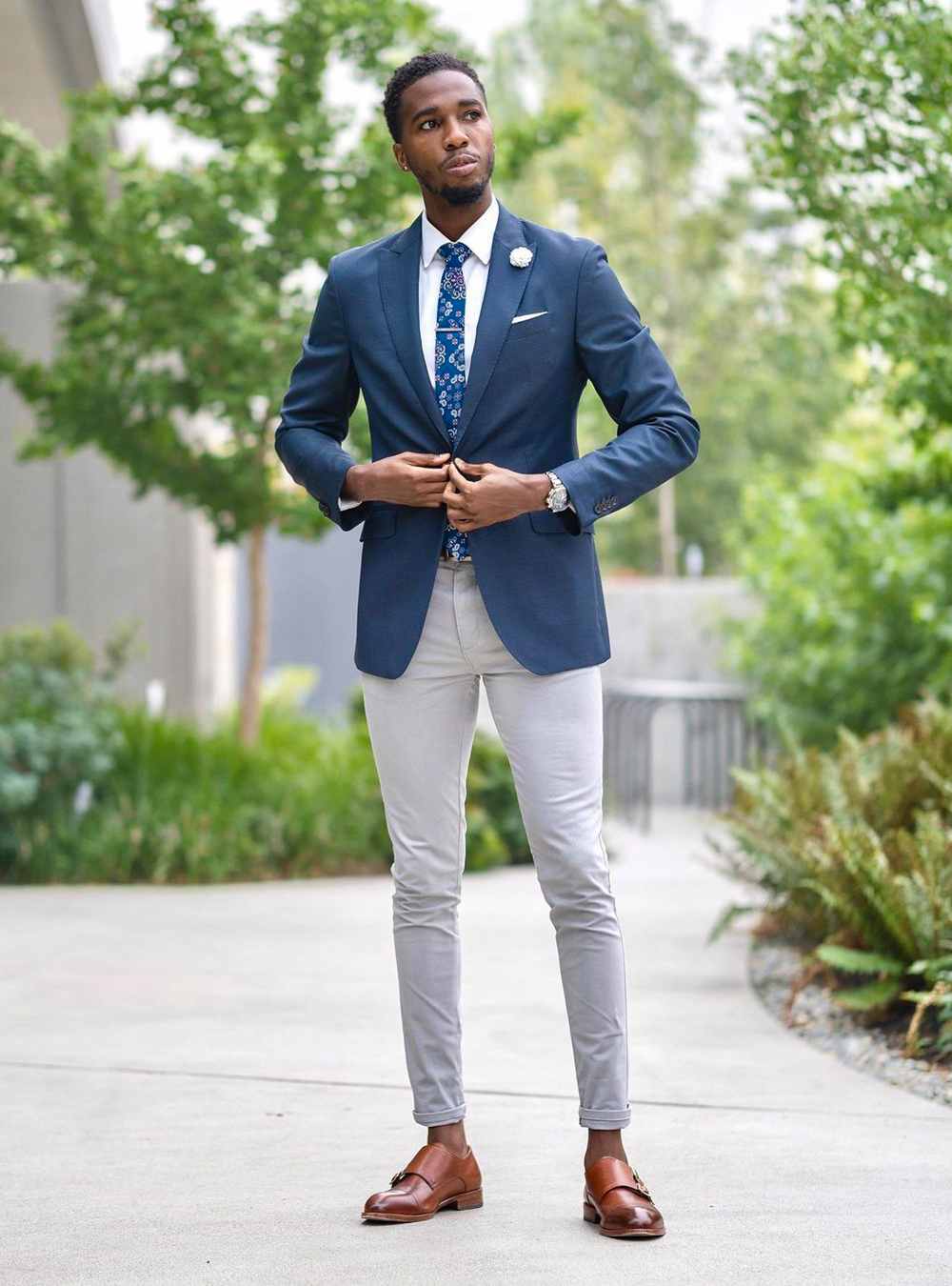 navy blue blazer, grey chinos, and brown cap toe monk straps