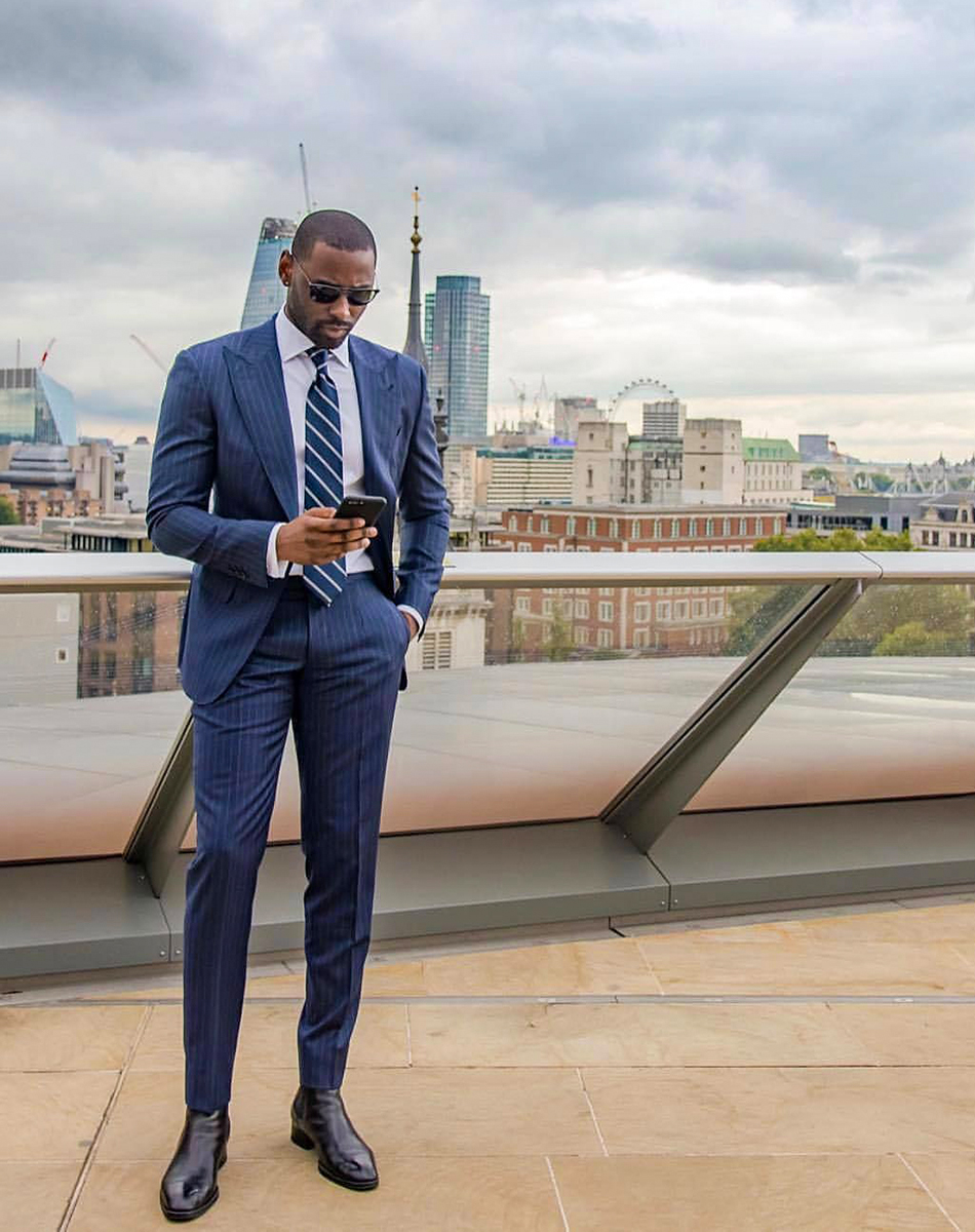 Navy blue pinstripe suit with black Chelsea boots