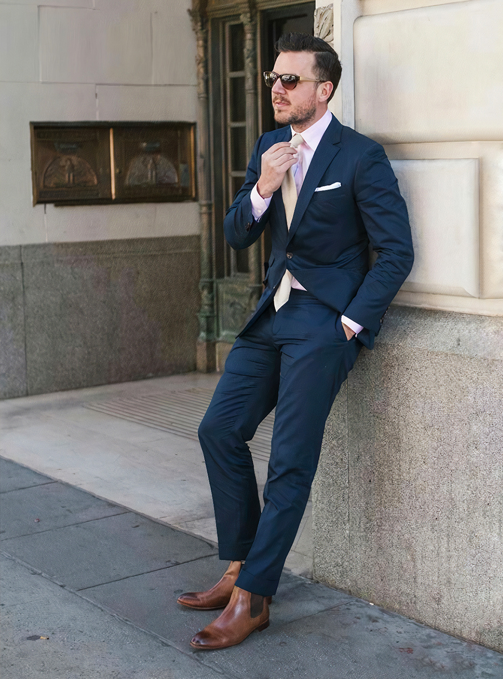 navy blue suit, light pink shirt and brown chelsea boots