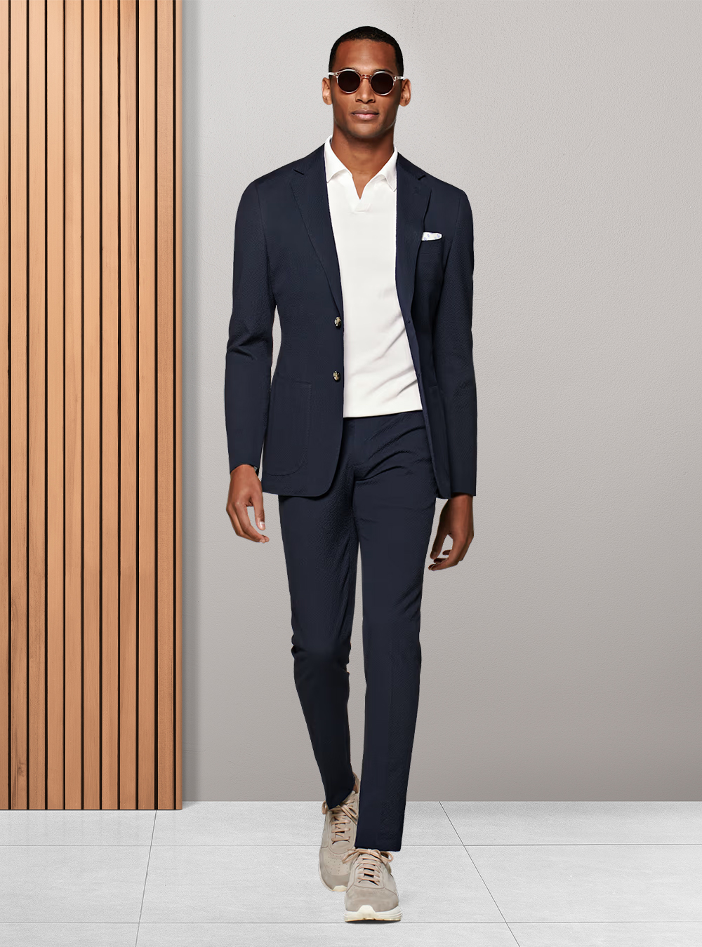 navy blue suit, white polo t-shirt, and grey sneakers