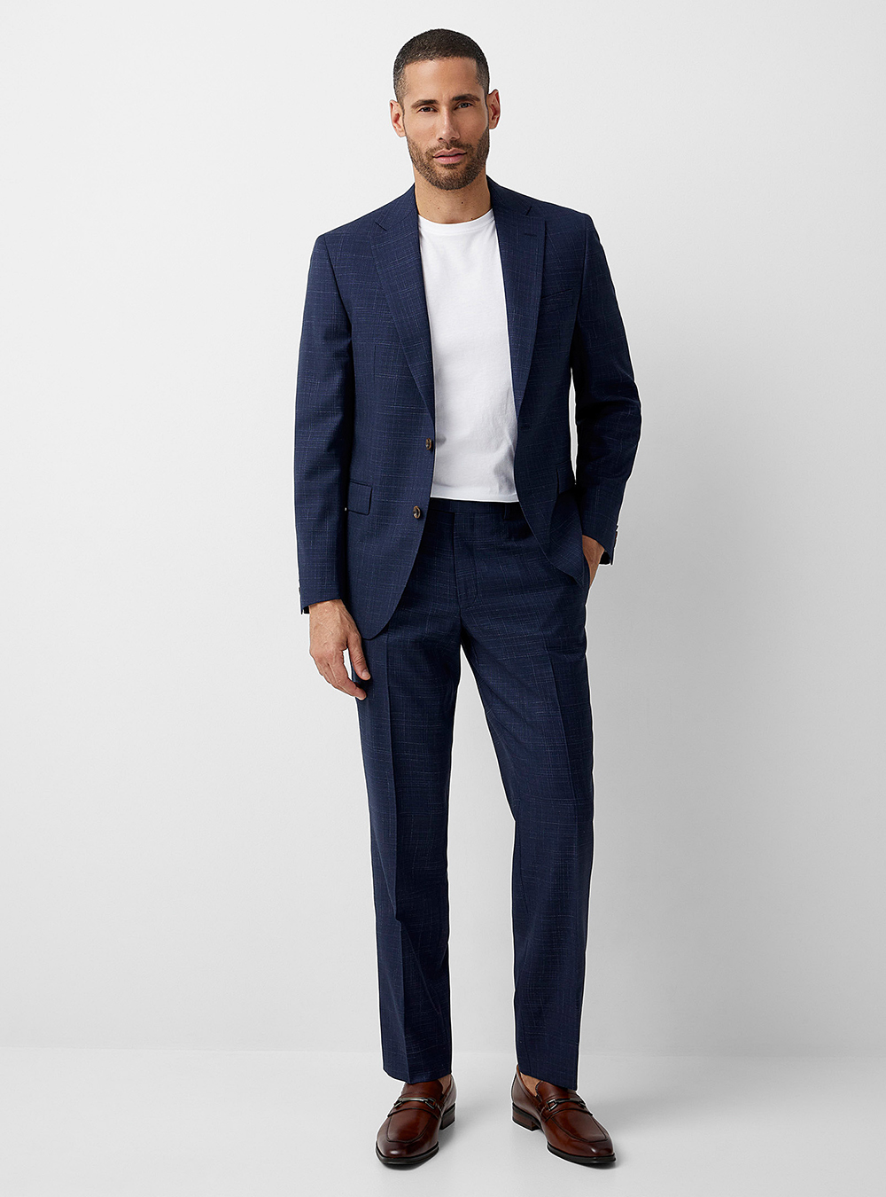 navy blue suit, white t-shirt, and brown loafers with no socks