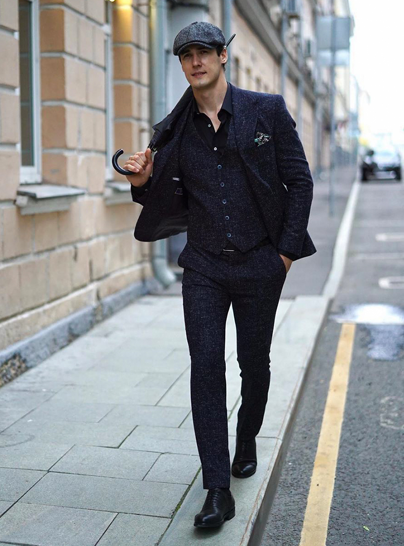 Navy blue three-piece suit, black shirt and black Oxford shoes