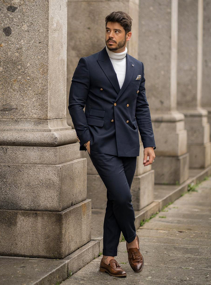 navy double-breasted suit, white turtleneck, and brown loafers