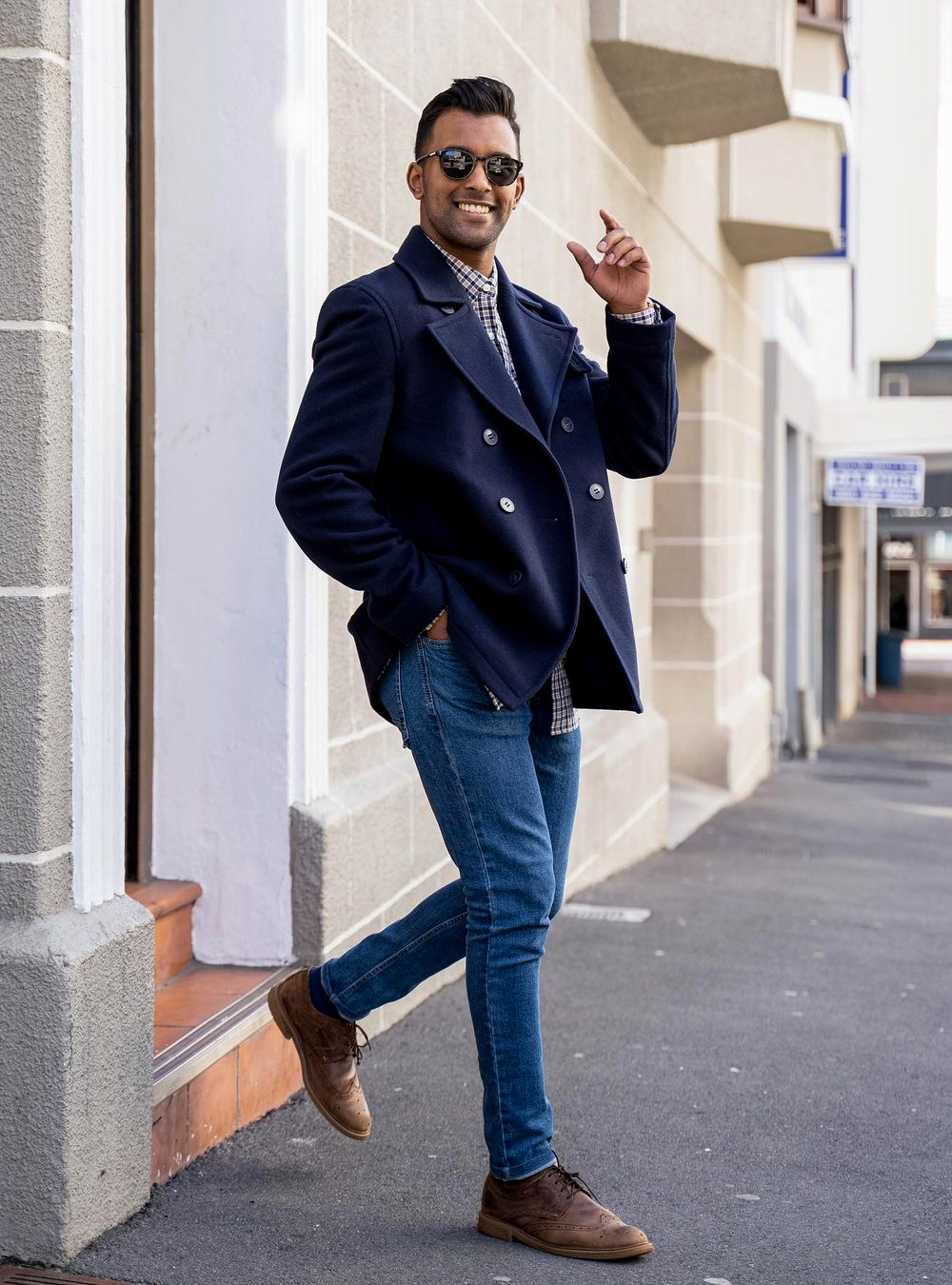 navy peacoat, gingham button-down shirt, and blue jeans