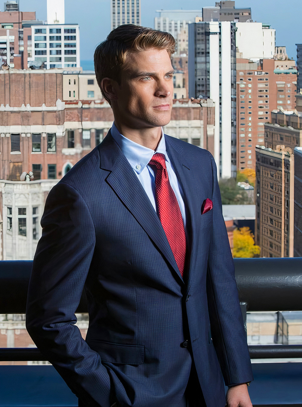 navy pinstripe suit, light blue shirt, and red tie