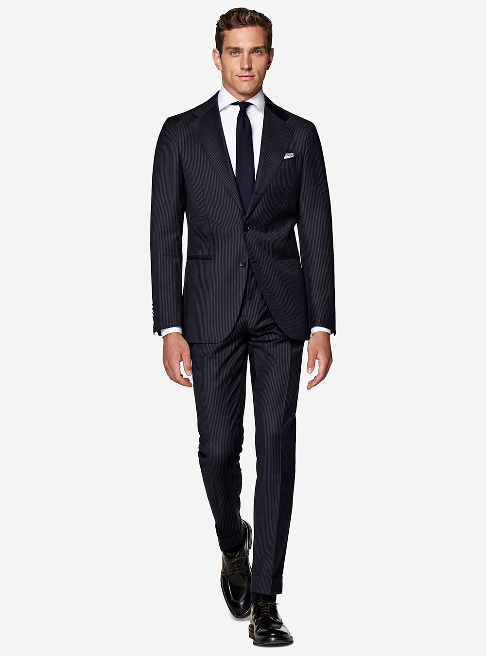 Navy pinstriped suit, white dress shirt, and black derby shoes