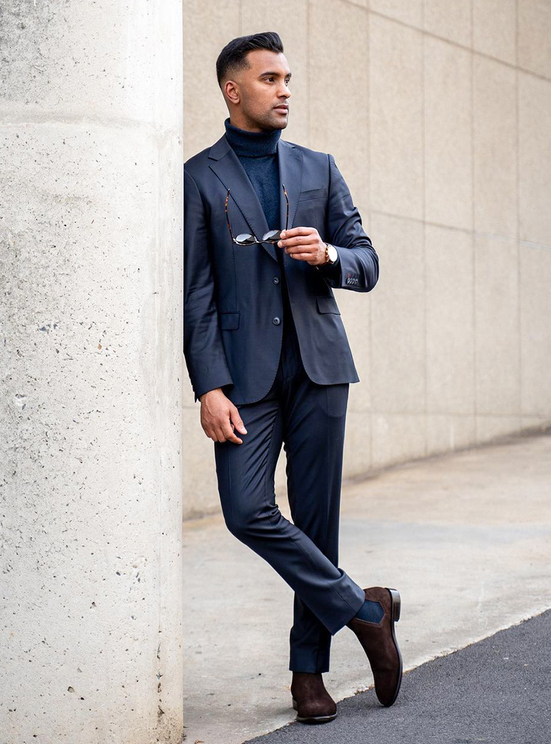 navy suit, blue turtleneck, and brown suede Chelsea