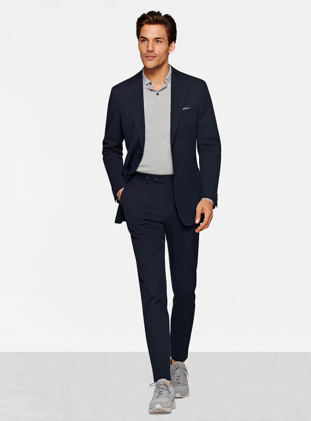 navy suit, grey polo shirt, and light grey sneakers