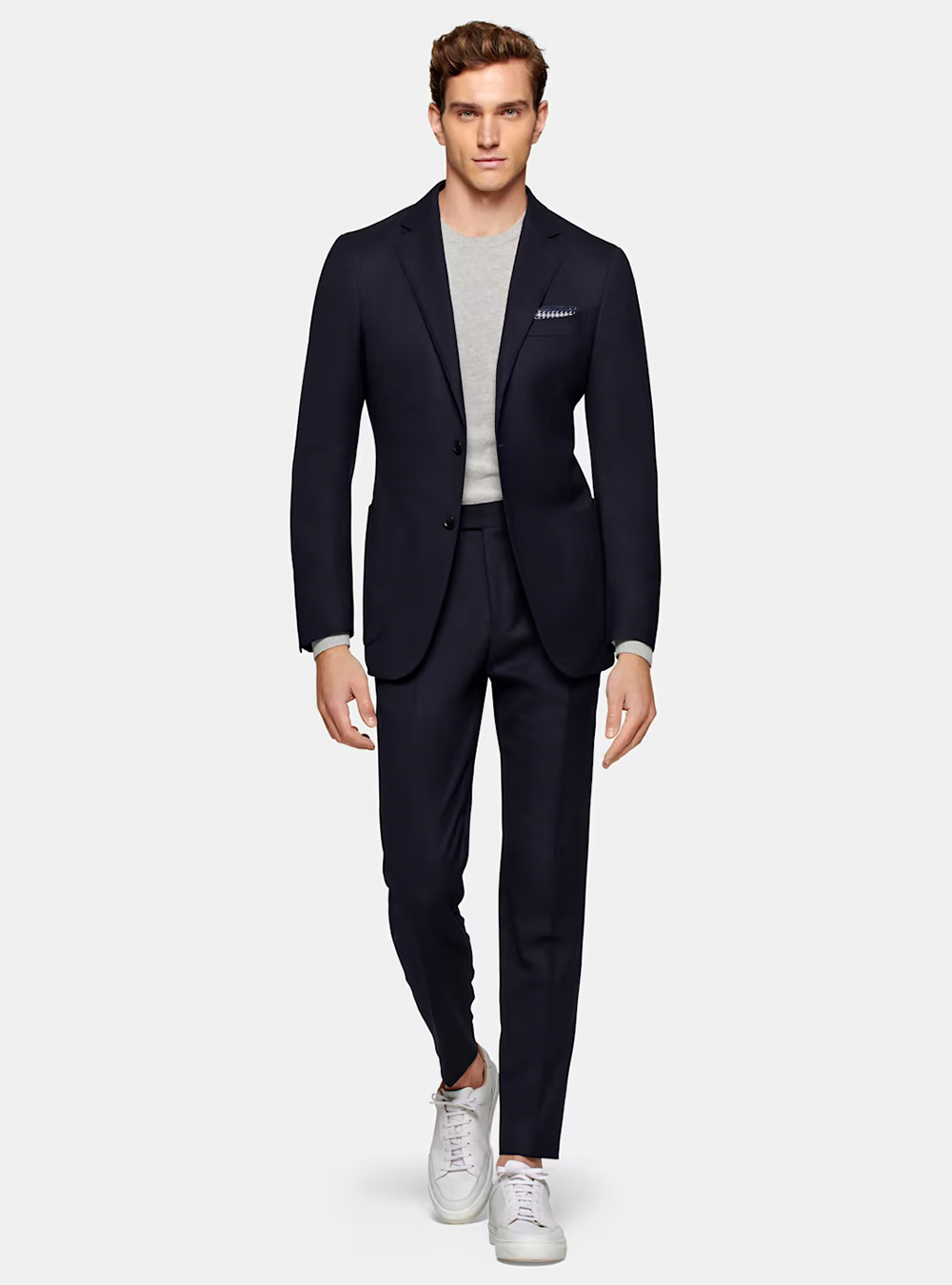 navy suit, grey t-shirt, and white sneakers