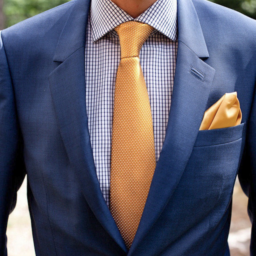 wearing navy suit jacket and golden pocket square