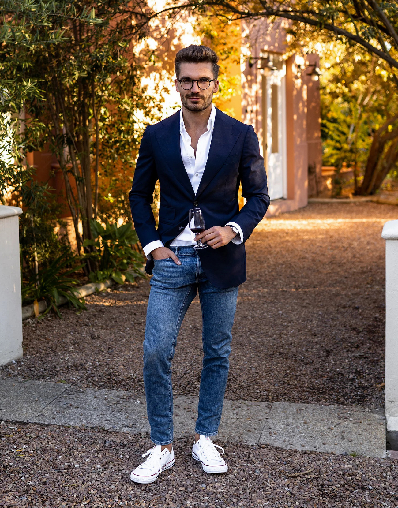 navy blazer, white shirt, blue jeans, and white sneakers