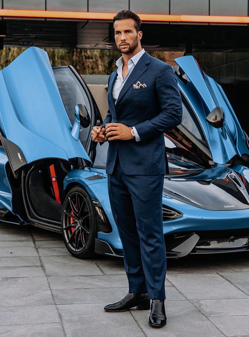 navy suit, light blue shirt, and black Chelsea boots