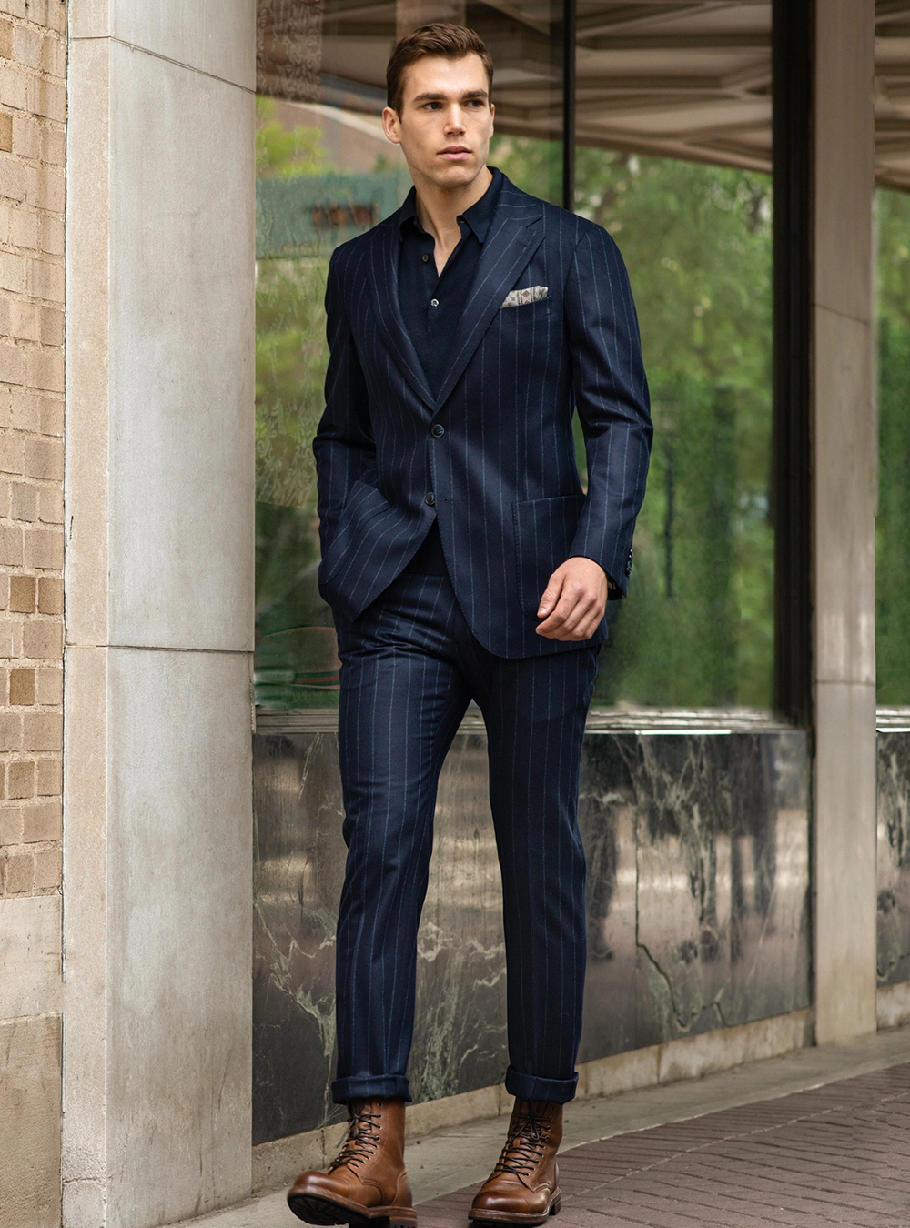 navy suit, navy polo t-shirt, and brown dress boots