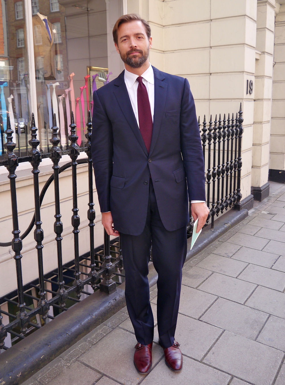 navy suit, white dress shirt, burgundy tie, and burgundy monk straps