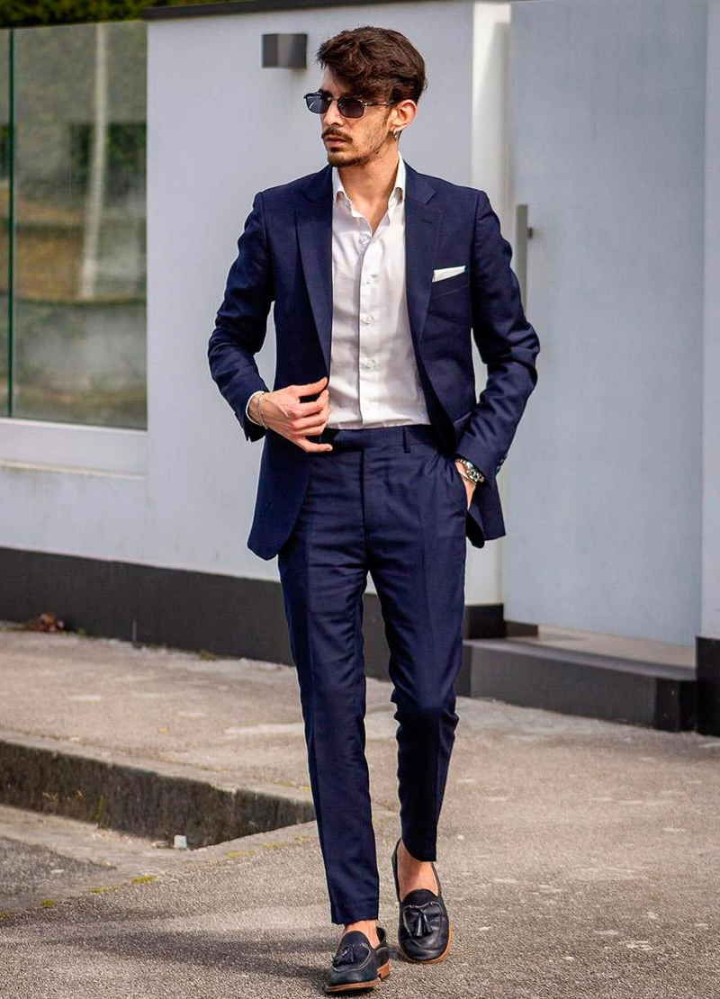 Navy suit, white shirt, and navy tassel loafers