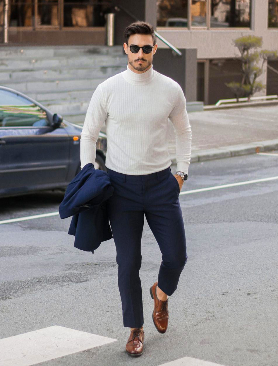 navy suit, white turtleneck, and brown derby shoes