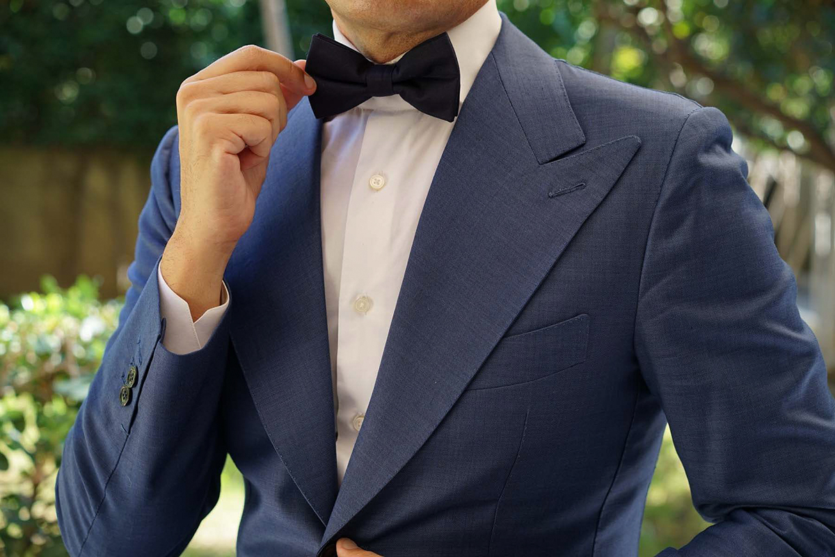 navy suit with white shirt and black bow tie