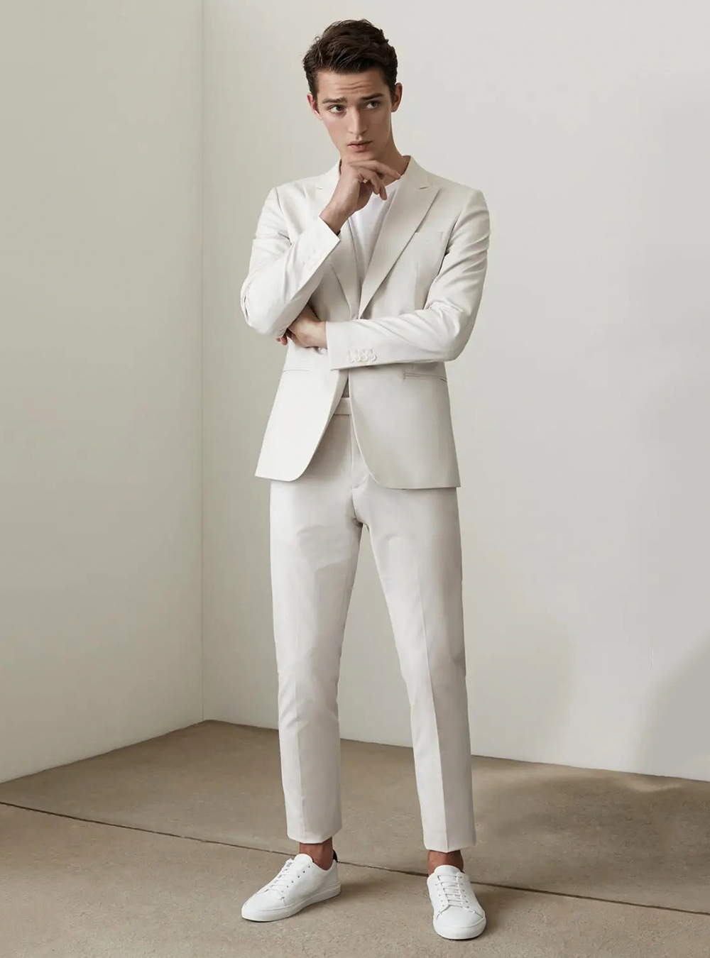 off-white casual suit, white t-shirt, and white sneakers