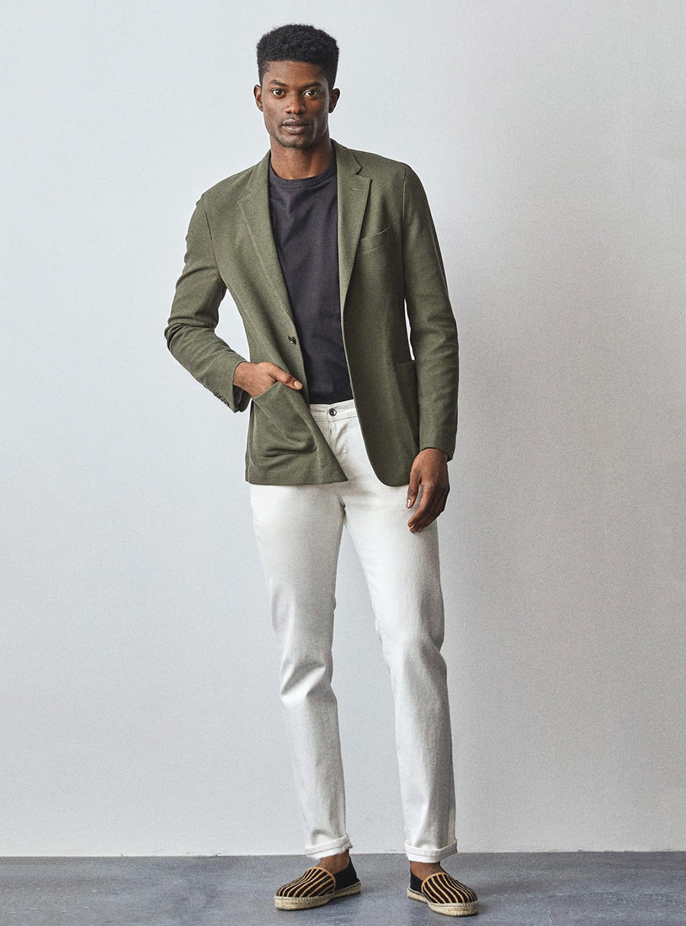 olive green blazer, navy T-shirt, white chinos, and navy espadrilles