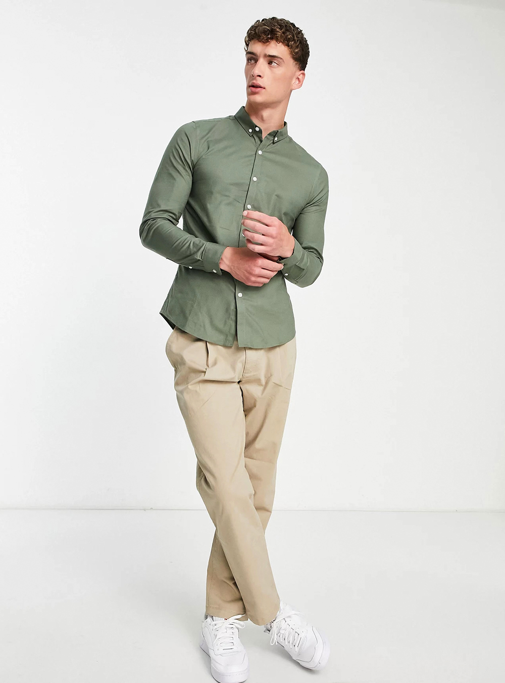 olive green button-down shirt, khaki pants, and white sneakers