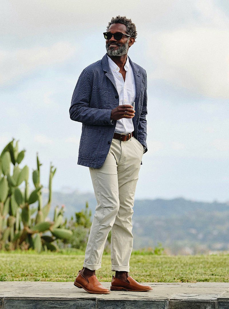 garden wedding: patterned blazer over a white shirt, beige pants, and brown loafers