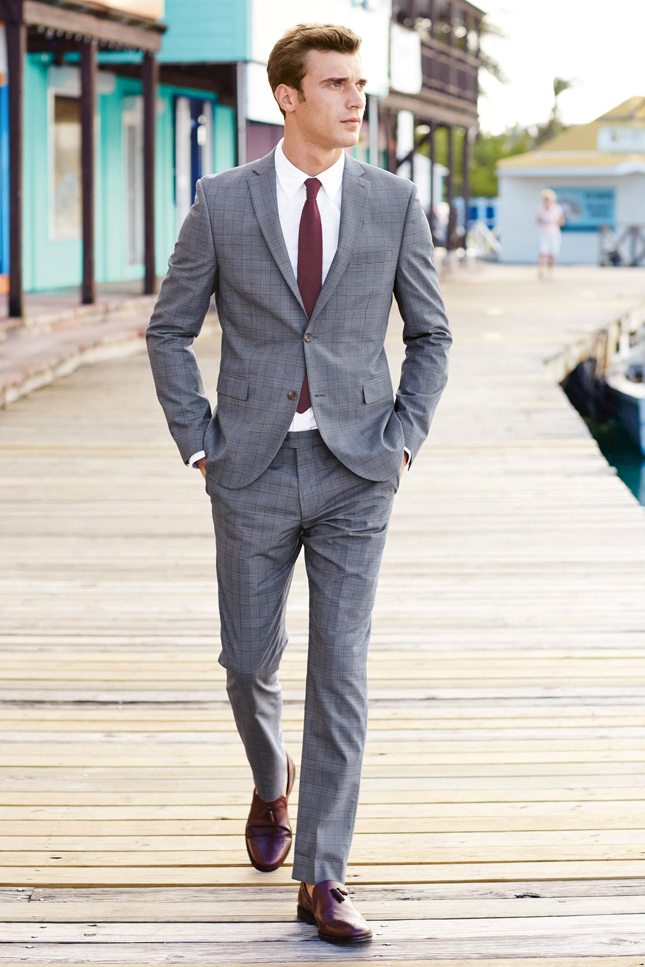 patterned light grey suit, white shirt, maroon tie, and burgundy loafers