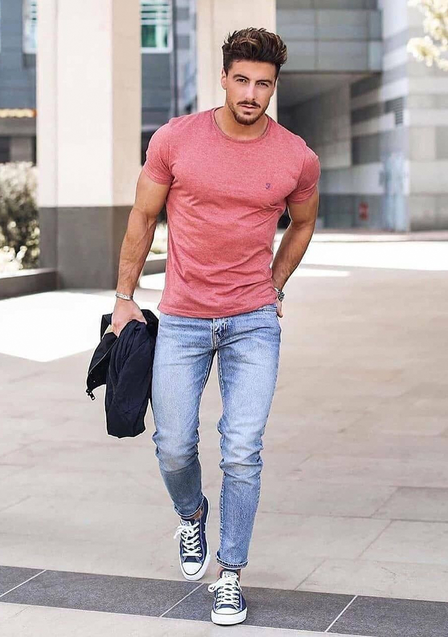 pink t-shirt, blue denim jeans, and navy blue sneakers