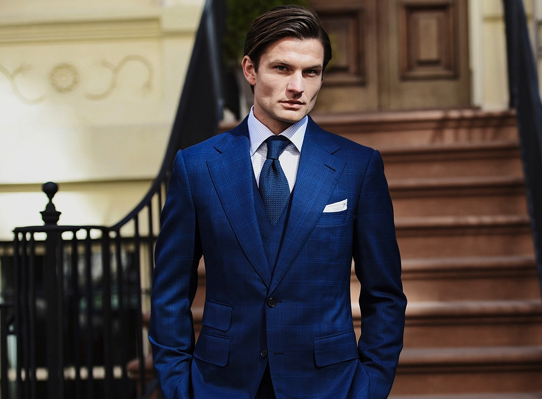 elegant blue suit with a white shirt and a blue tie displays confidence