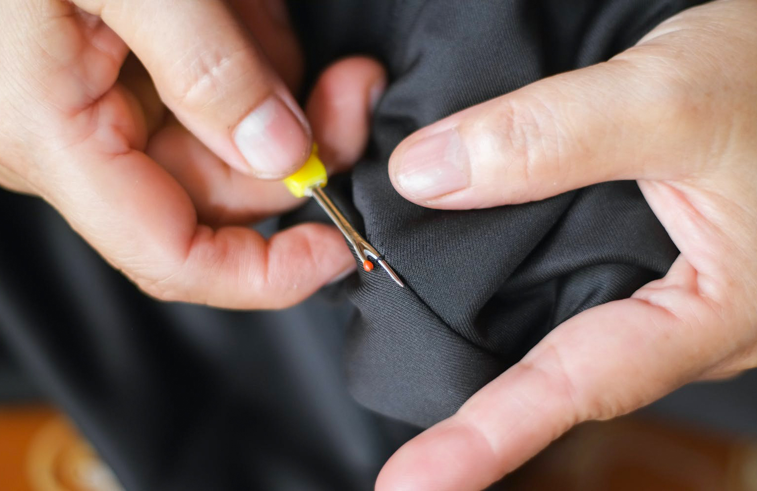hand-stitching the suit pockets